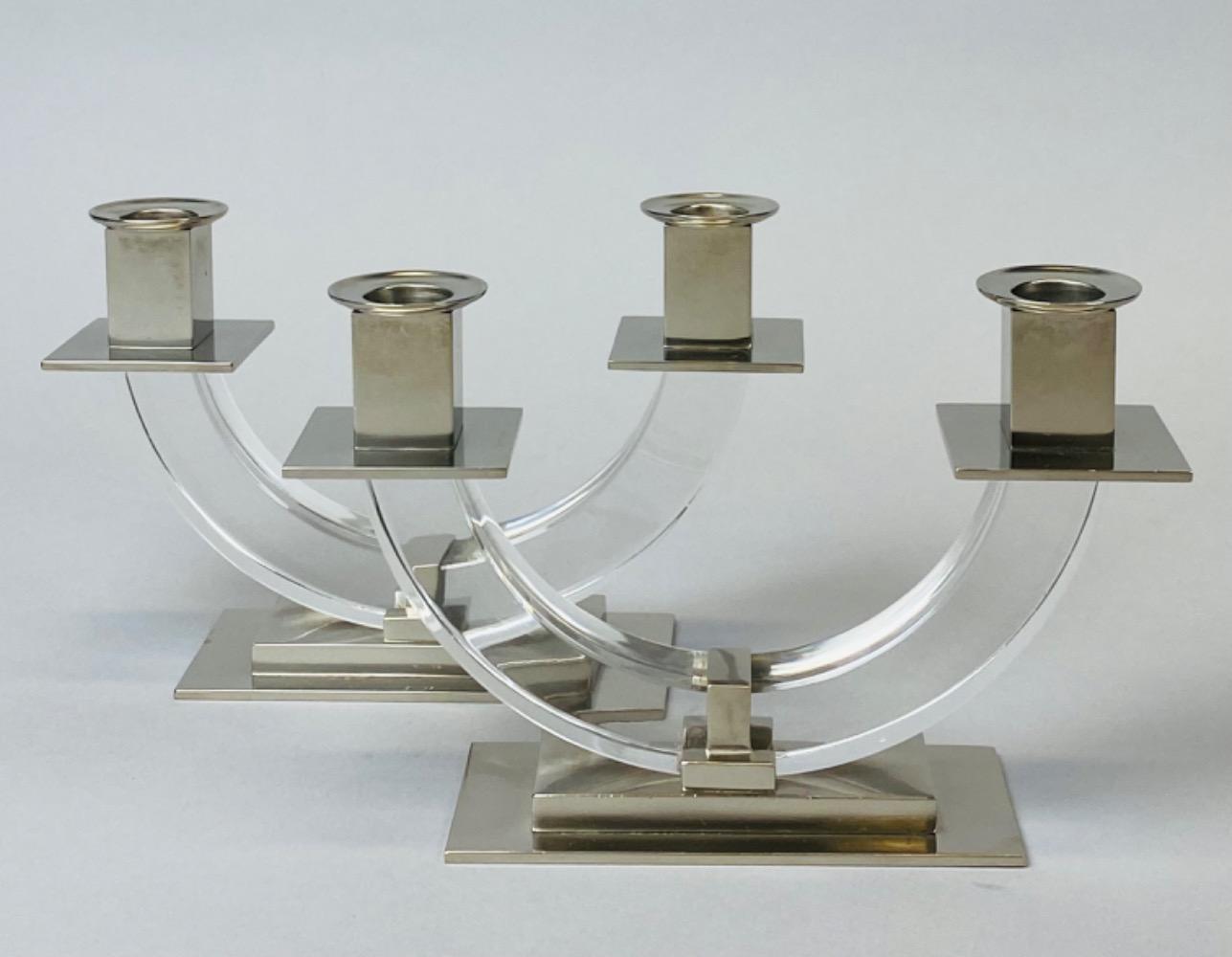 Pair of modernist candelabras attr. to Jacques Adnet.