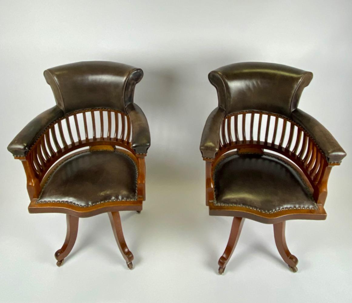 Pair Victorian mahogany & leather revolving desk chairs.