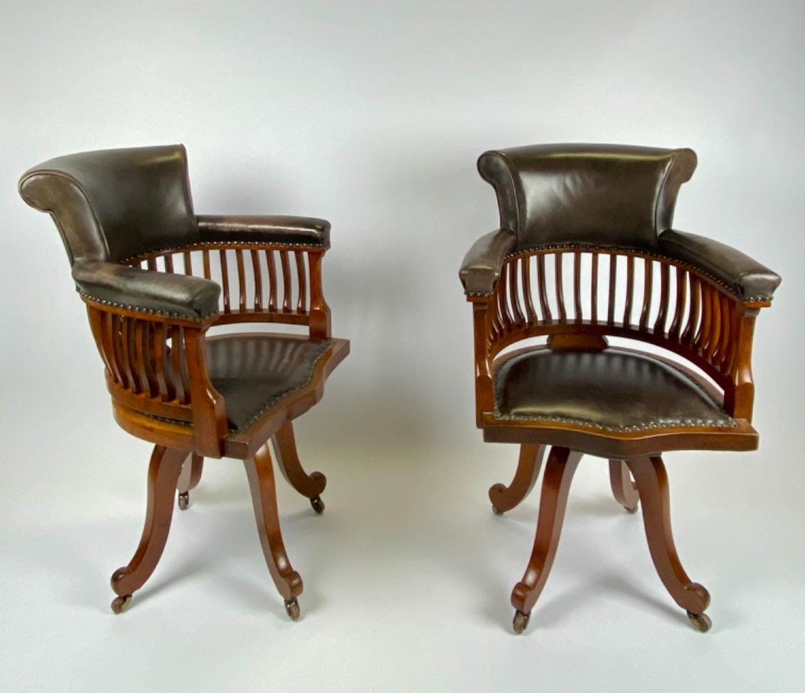 Pair Victorian mahogany & leather revolving desk chairs.