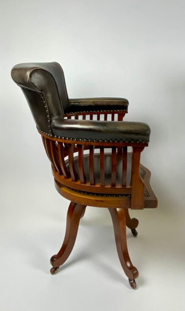 Pair Victorian mahogany & leather revolving desk chairs.