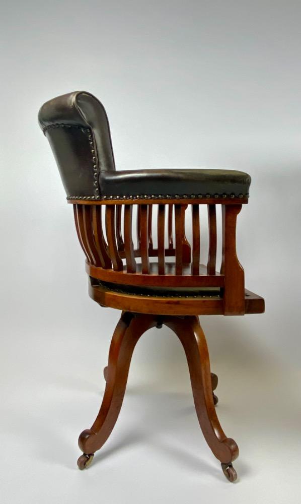 Pair Victorian mahogany & leather revolving desk chairs.