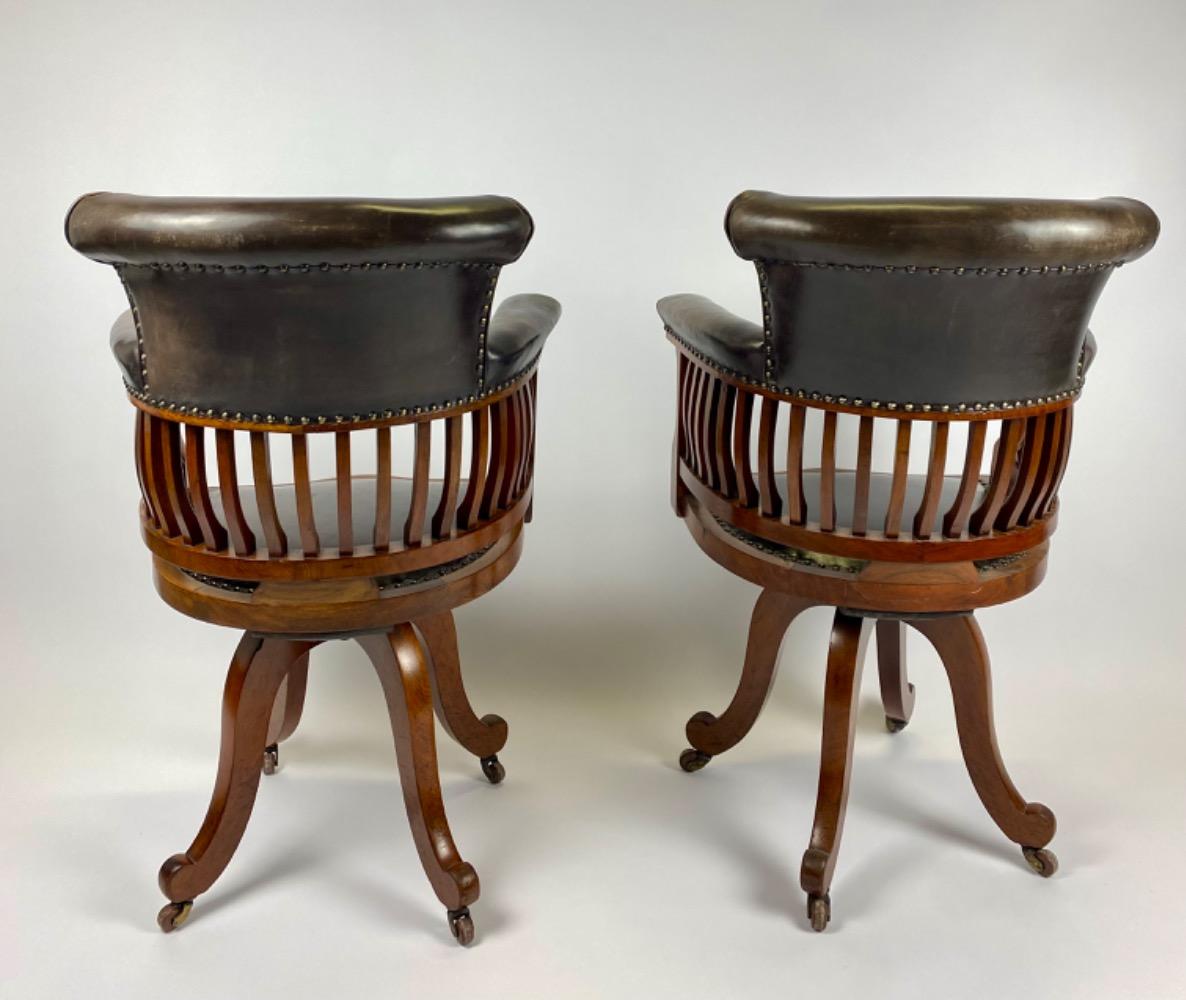 Pair Victorian mahogany & leather revolving desk chairs.