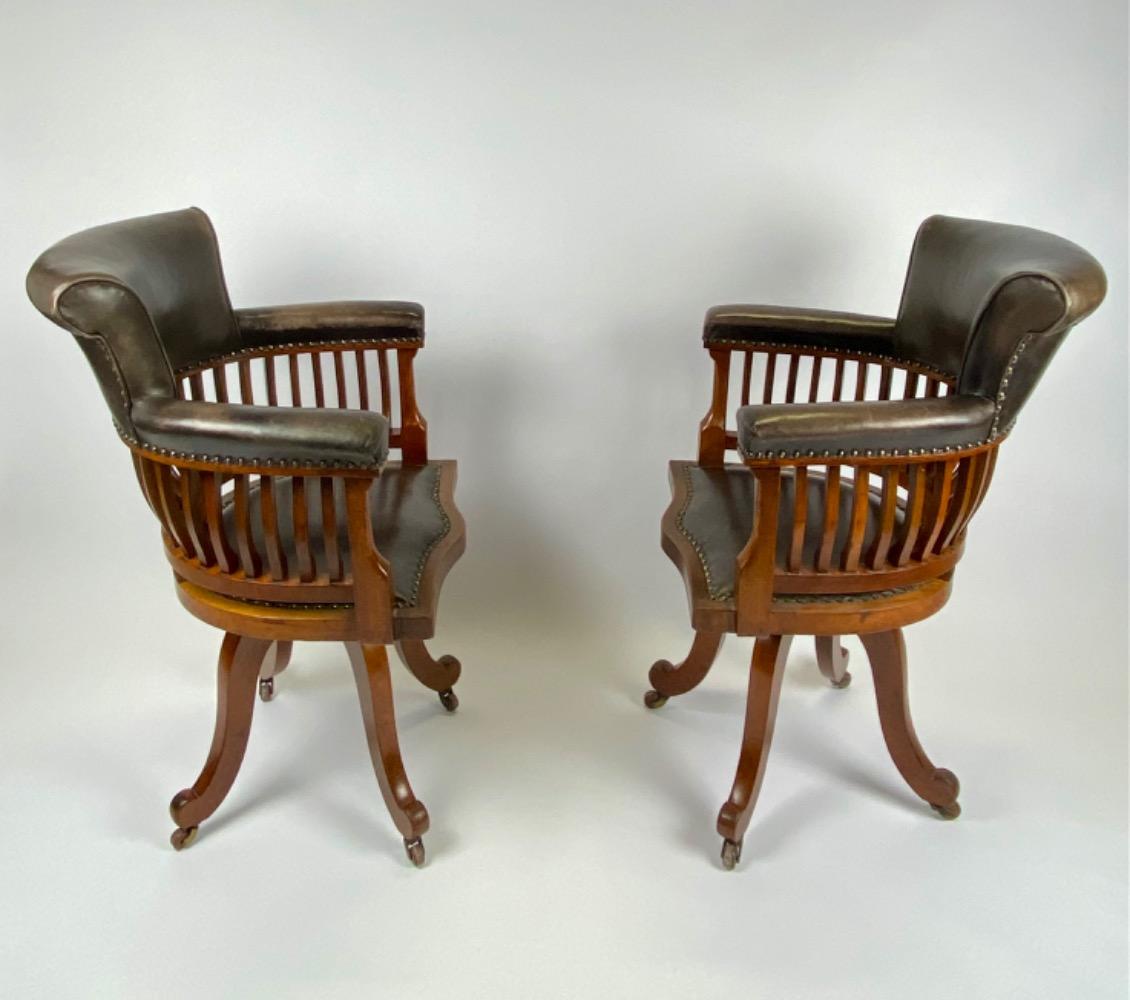 Pair Victorian mahogany & leather revolving desk chairs.