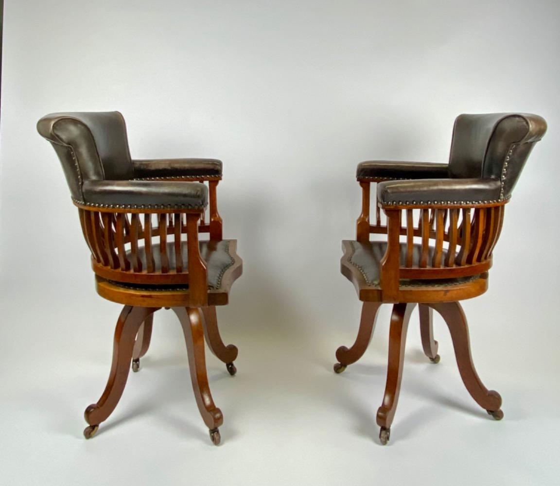 Pair Victorian mahogany & leather revolving desk chairs.