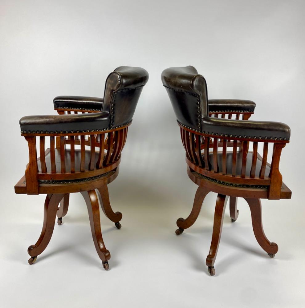 Pair Victorian mahogany & leather revolving desk chairs.