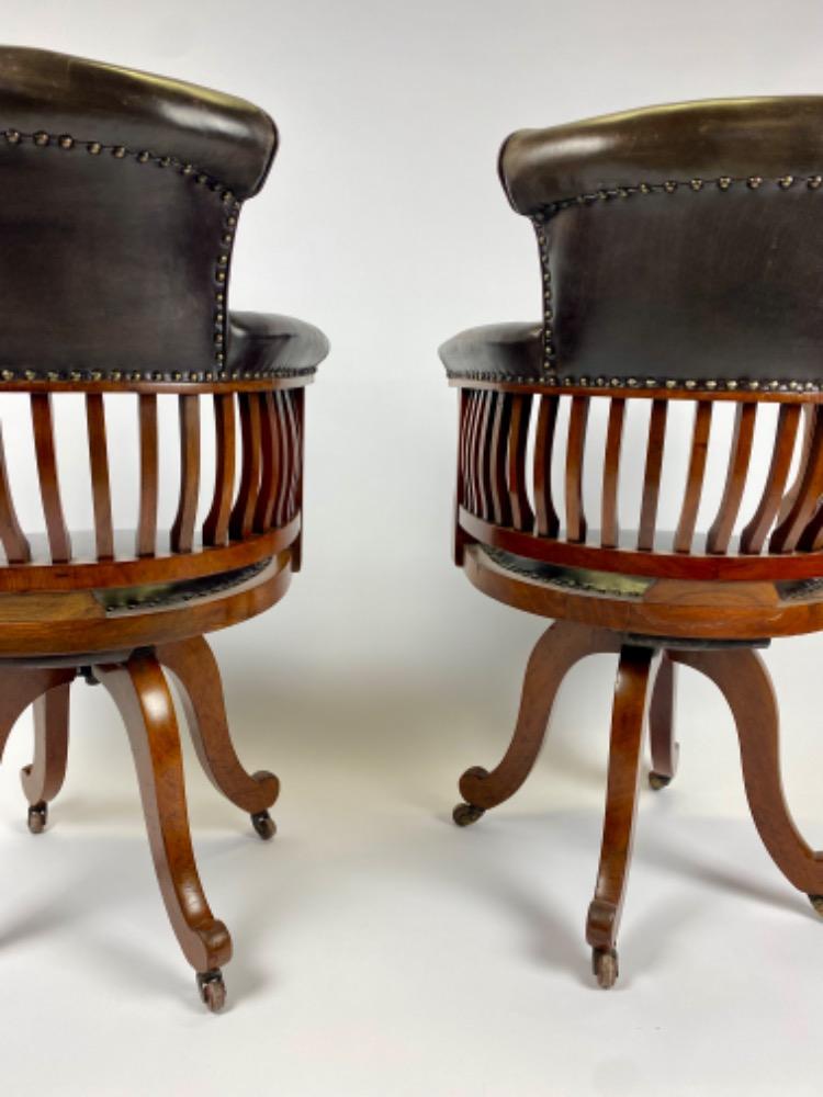 Pair Victorian mahogany & leather revolving desk chairs.